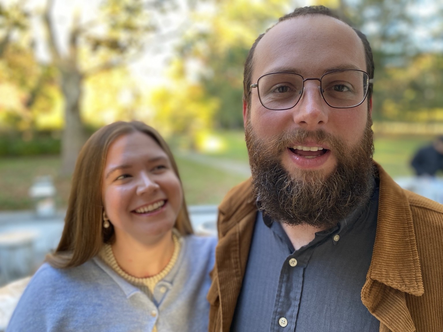 Emily and Henry smiling together outside